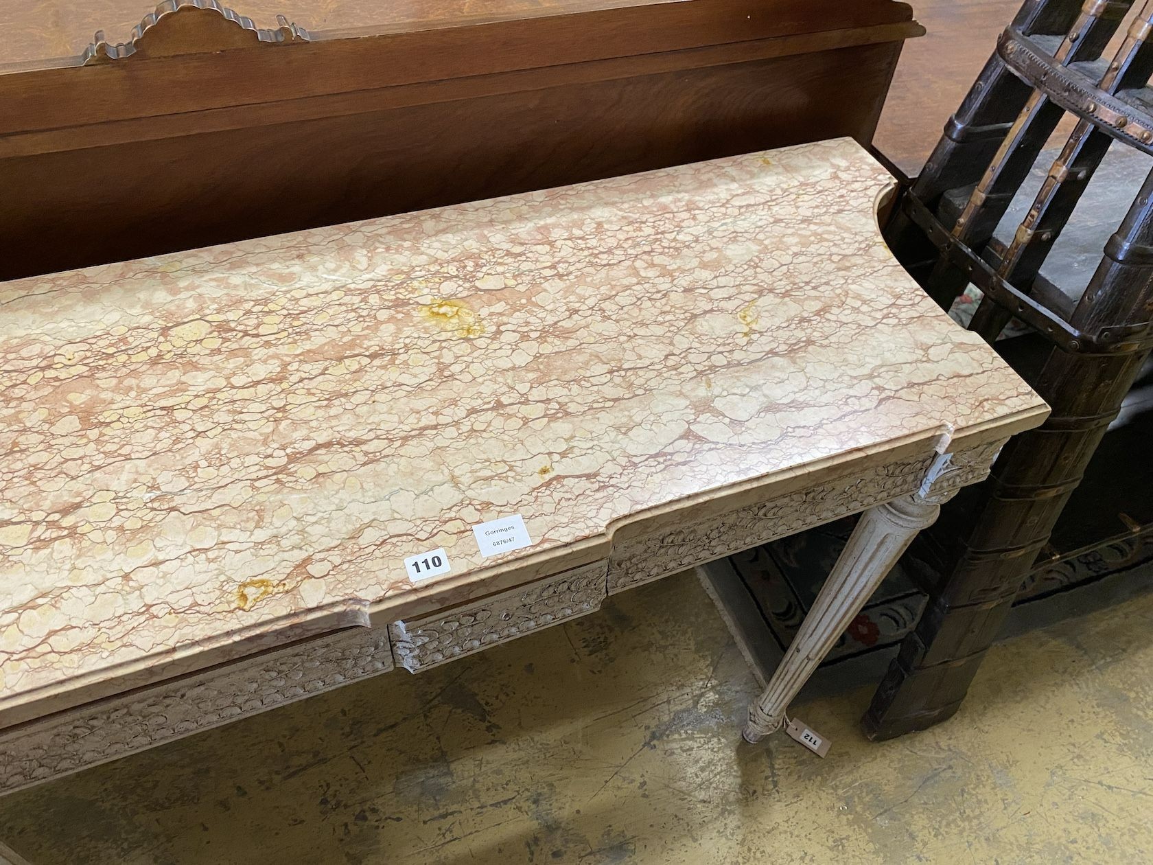 A Louis XVI style white painted carved wood marble topped two drawer console table, width 110cm, depth 47cm, height 82cm